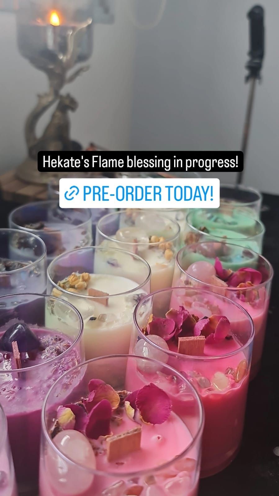 Assorted colorful candles with decorations in glass jars on a table.
